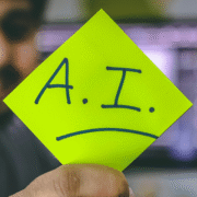 someone hold a green paper with ai written on it
