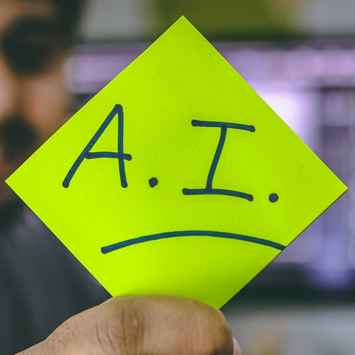 someone hold a green paper with ai written on it